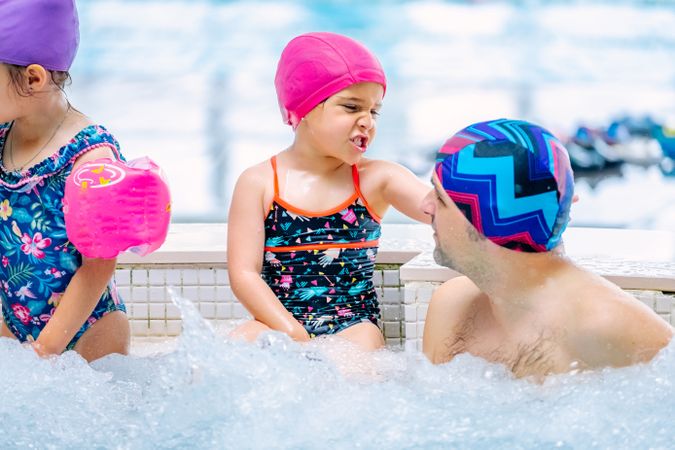 Family relaxing in bubbling pool