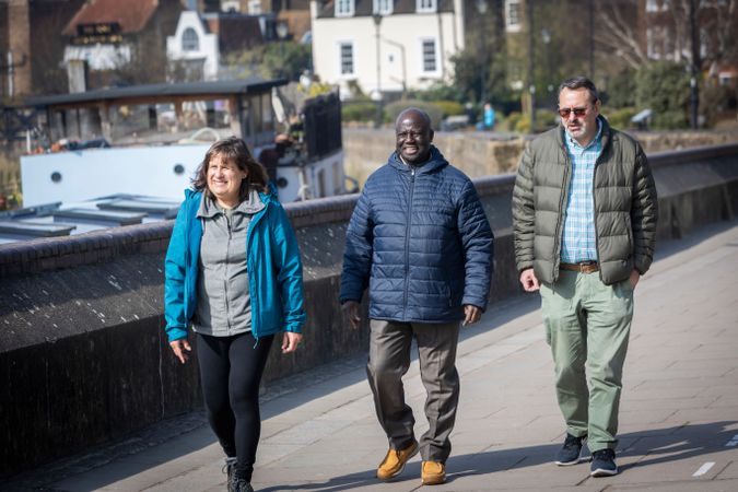 Multi-ethnic group of older adults going for a stroll outside