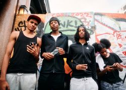 London, England, United Kingdom - August 28, 2022: Group of Black male friends standing in London st