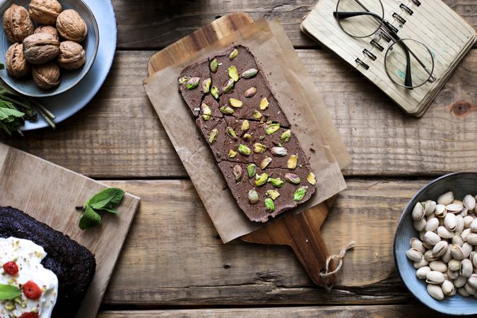Chocolate dessert sprinkled with pistachios on table