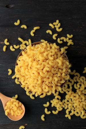 Raw Macaroni on Black Wooden Background