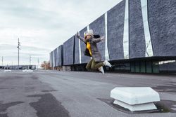 Blonde woman jumping on the street