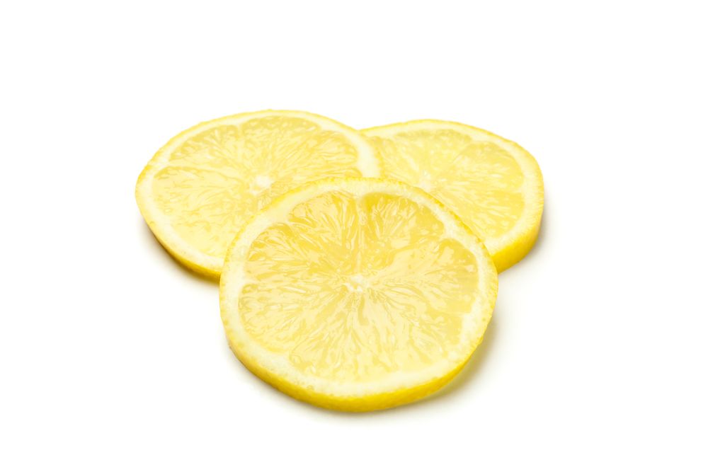 Lemons slices isolated on light background. Ripe fruit