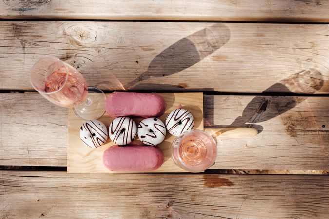 Pink wine near tasty donuts