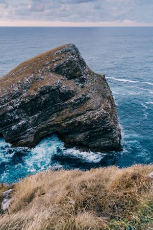 Sea waves crashing near cliff