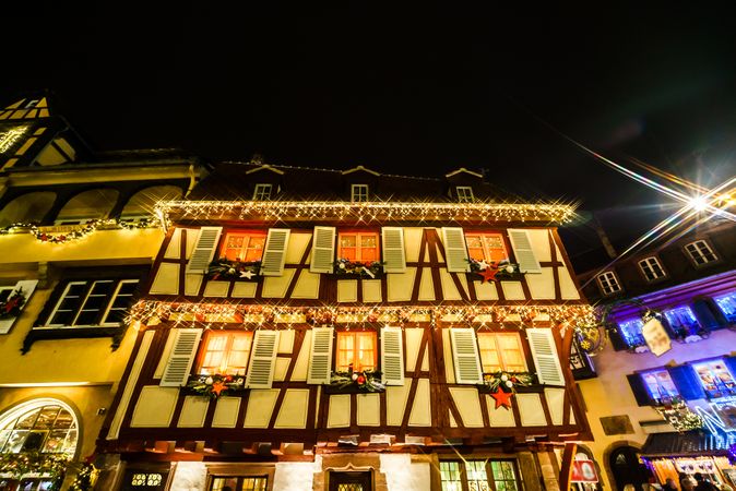Facade of building with colorful Christmas highlighting in Colmar, Alsace, France