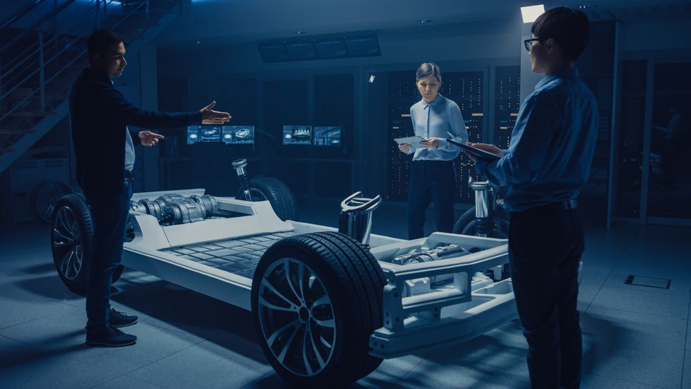 Automobile Engineers Designing Electric Car Platform Chassis, Using Tablet Computers with CAD Software for 3D Concept
