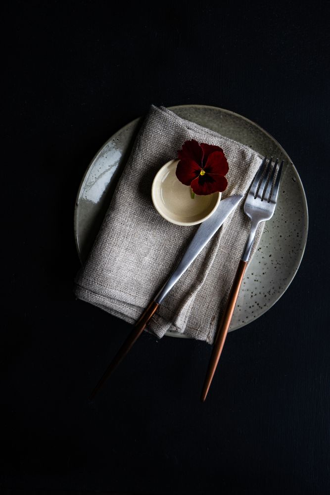 Top view of grey plate with red flower