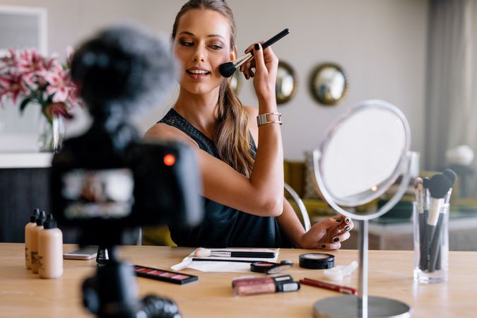 Beautiful woman demonstrating makeup applications