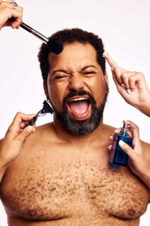 Many hands grooming beard man