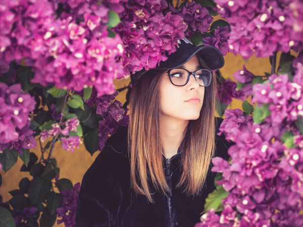 Woman on background of stunning violet flowers
