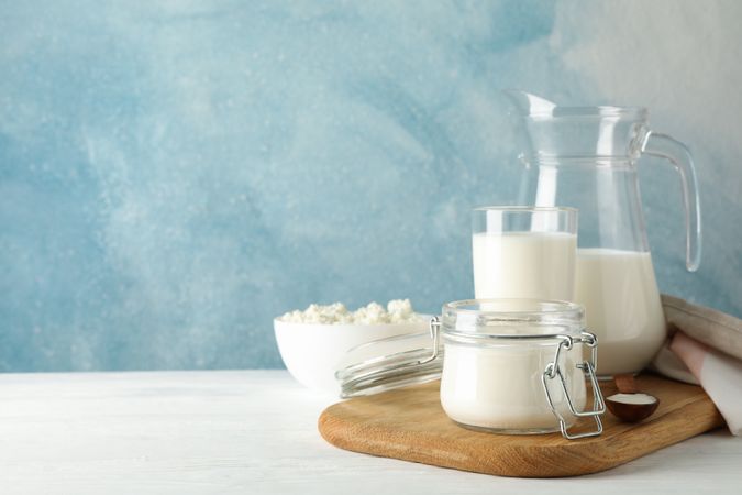 Fresh dairy products on plain wooden table, copy space
