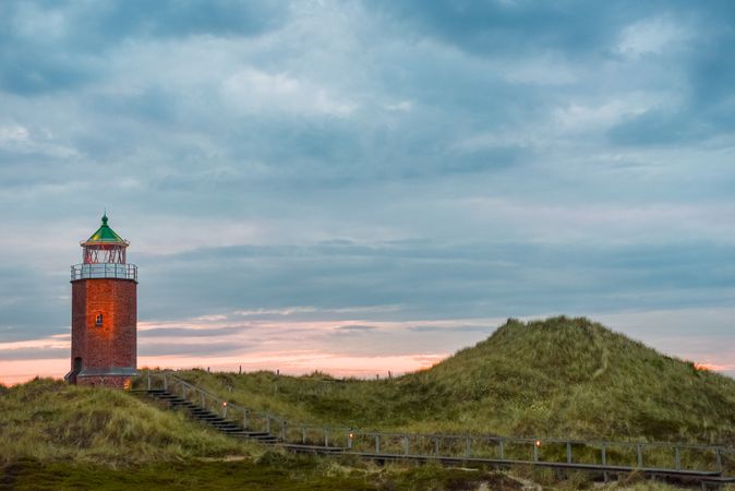 Sunset scenery with an old lighthouse on the hills of Sylt island, in North Sea, Germany