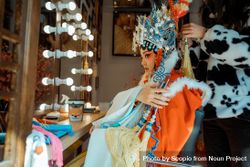 Side view of Chinese actress in her cultural outfit getting ready for stage performance bDJDJ5