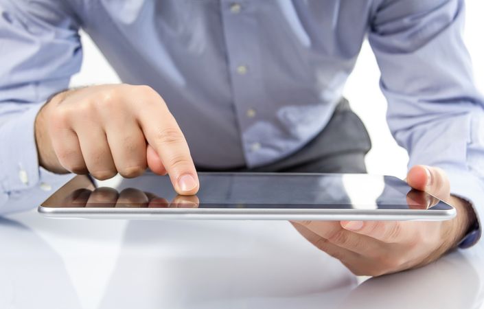 Man fingers touching screen on digital tablet