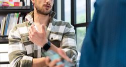 Banner of man talking to colleague in office