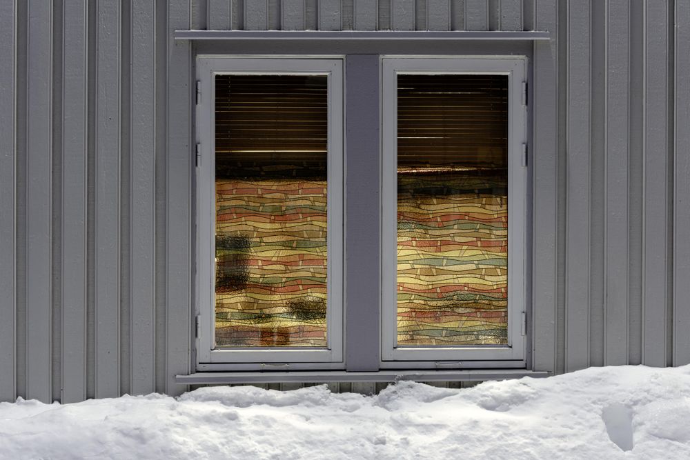 Stained glass windows on grey building