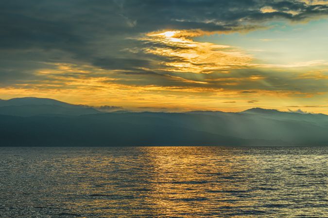 beautiful lake view at sunrise with mountain and dramatic clouds