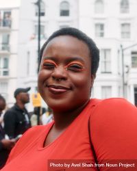 London, England, United Kingdom - August 28, 2022: Black woman outside with orange eye make up 5rr975