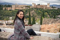 Content female enjoying view of big ancient castle