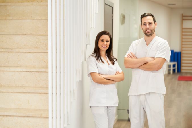 portrait of two physiotherapists in their clinic looking at the