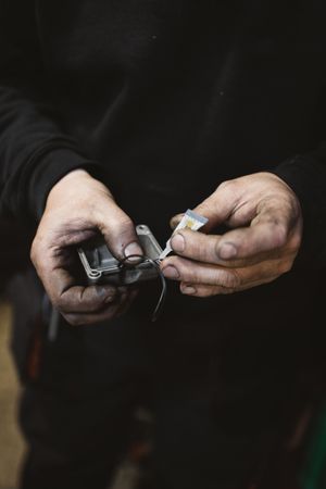 Crop man repairing detail