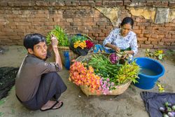 Bagan, Myanmar - June, 25 2012: people selling flowers on street