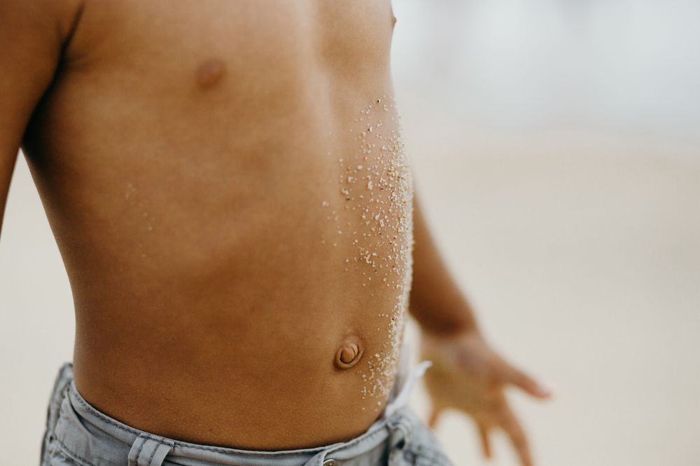 Crop Black child with dirty belly