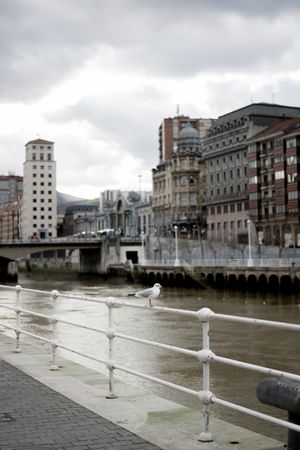Cloudy sky over buildings and channel