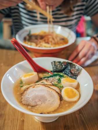 Female eating Japanese dish
