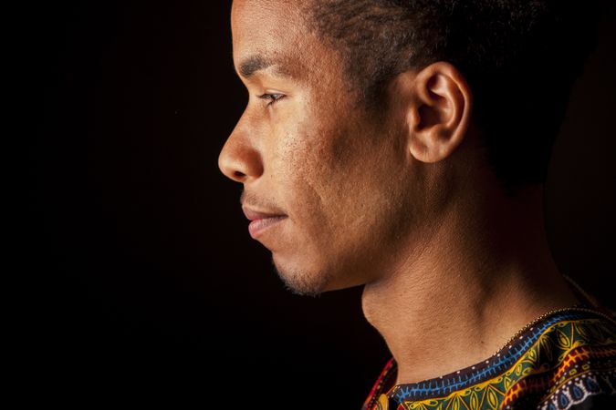 Black man smiling and looking away