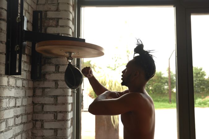Black guy boxing in gym