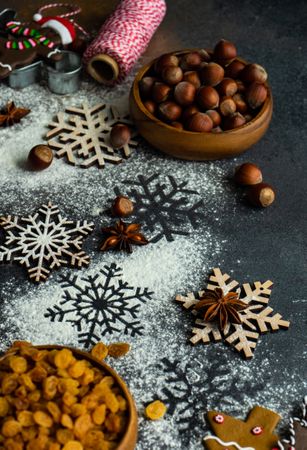Flour on counter with Christmas baking ingredients and snow flakes