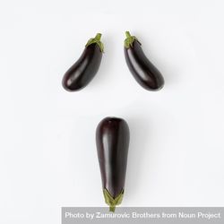 Flat lay of eggplant on light background in haunting face 42e6g5