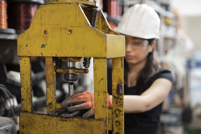 Woman using yellow heavy machine