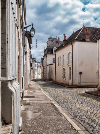 Empty streets of the medieval city of Beaune in Burgundy. The stormy sky