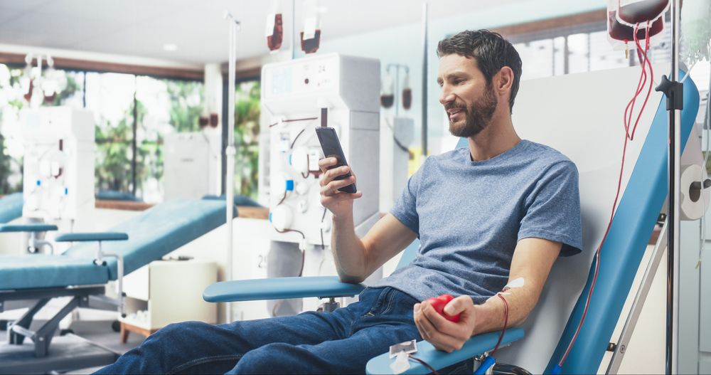 Man Donating Blood For People In Need In Hospital.