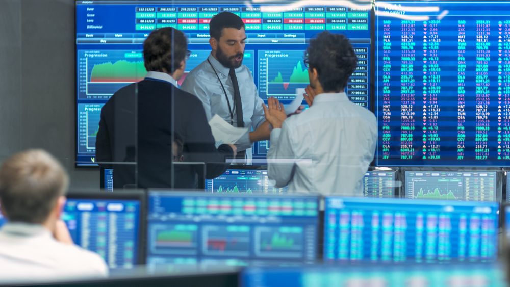Three Experienced Stock Traders Talking Business, Consulting Documents and Argue About Data.