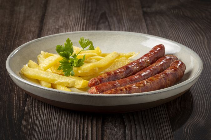 Grilled German sausage with french fries.