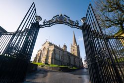 Entrance gates and cathedral on sunny spring day