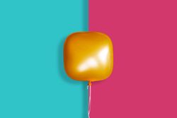 A single bright square orange balloon