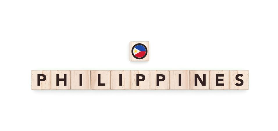 Wooden blocks bearing the name and flag of Philippines. Filipino and Asian Culture, national identity, travel, and geography in a copy space design.