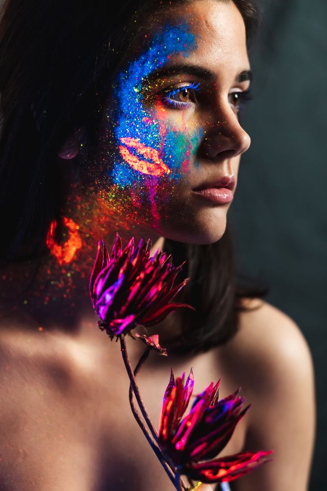 Young woman covered with uv painting