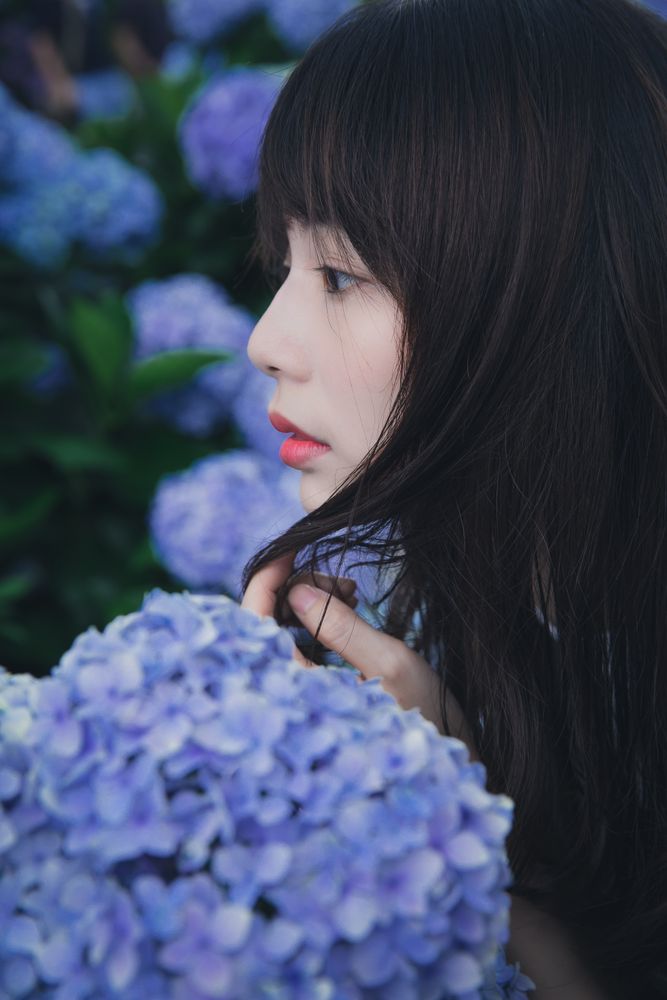 Woman near purple flower in close-up