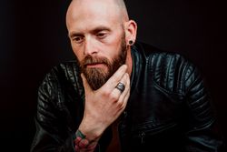 Pensive young bearded guy