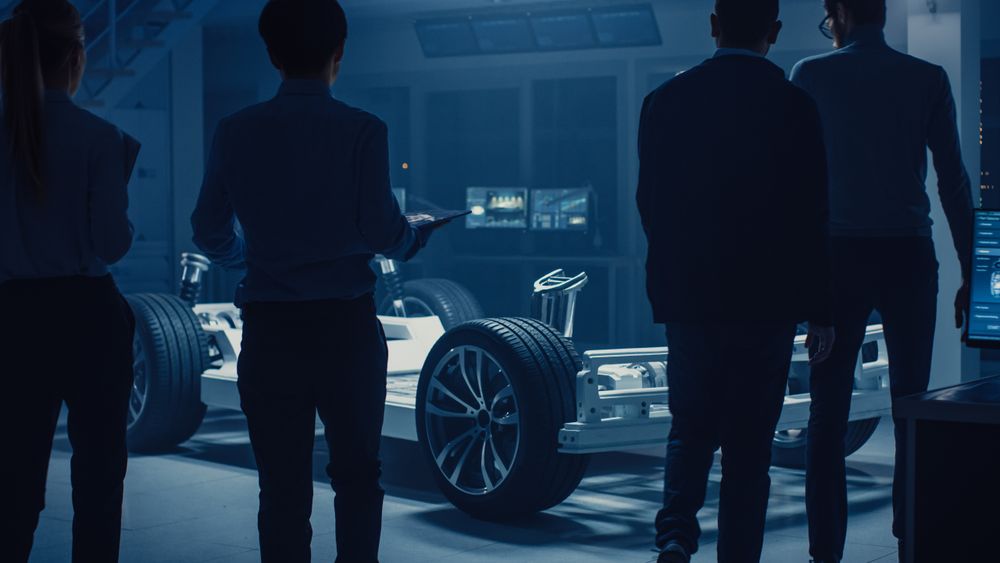 Team of Automobile Design Engineers Enter Automotive Innovation Facility Start Working on Electric Car Platform Chassis Prototype