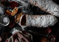 Pieces of Stollen near sieve and autumn leaves