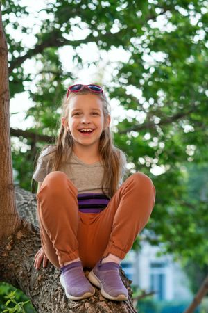 Girl relaxing on tree branch