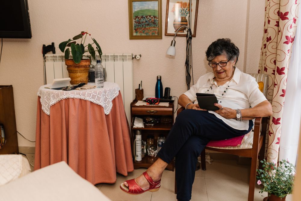 Mature female reading e-book at home
