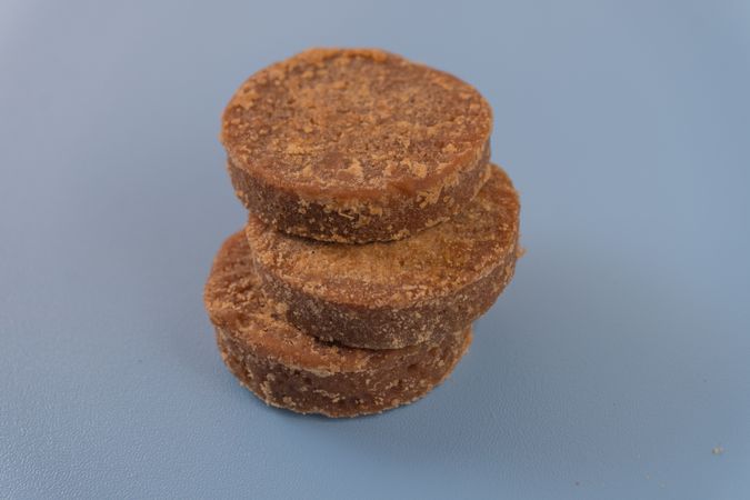 A stack of traditional palm sugar (gula merah) blocks arranged neatly